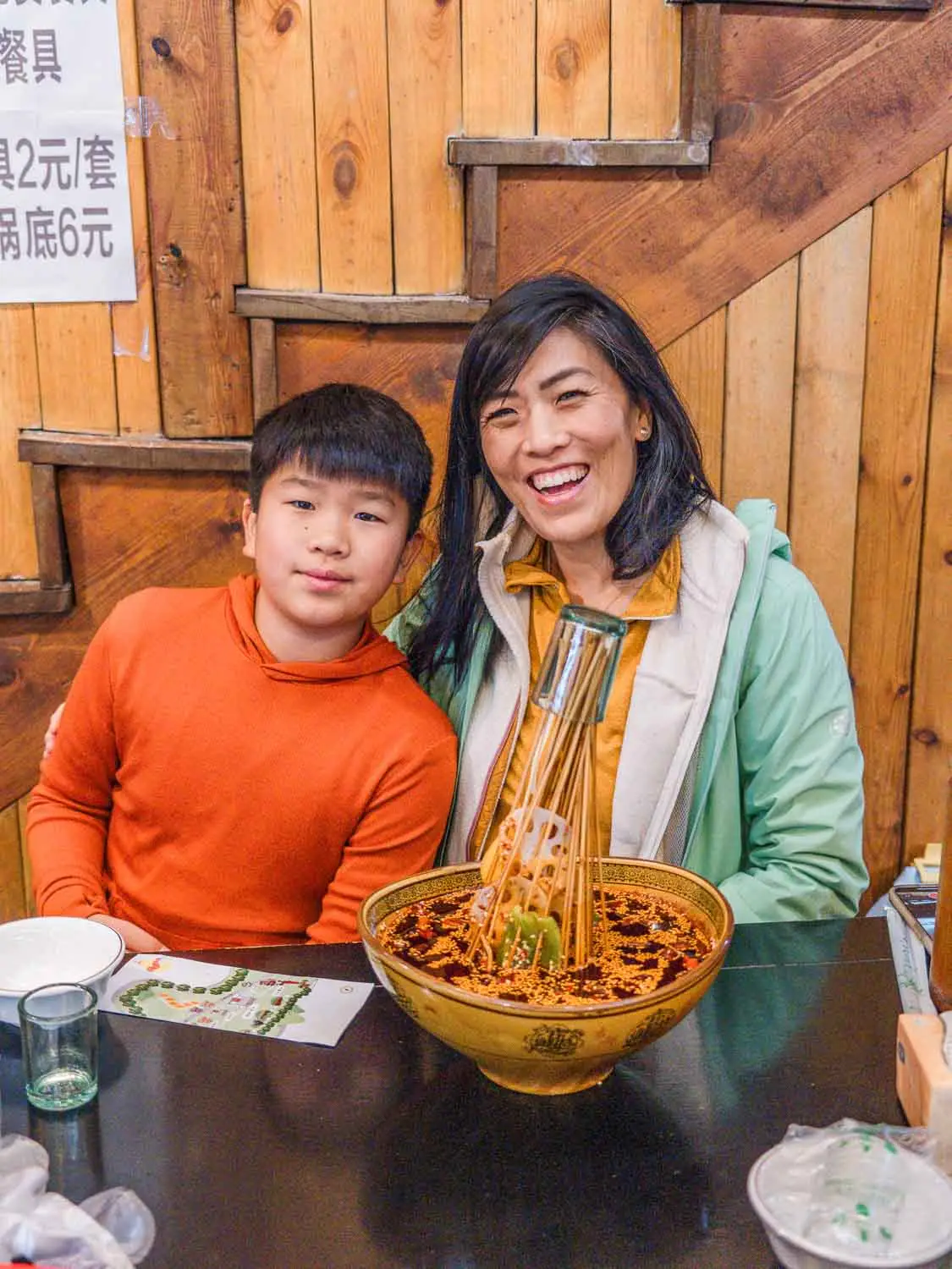 Mother and son eating skewers